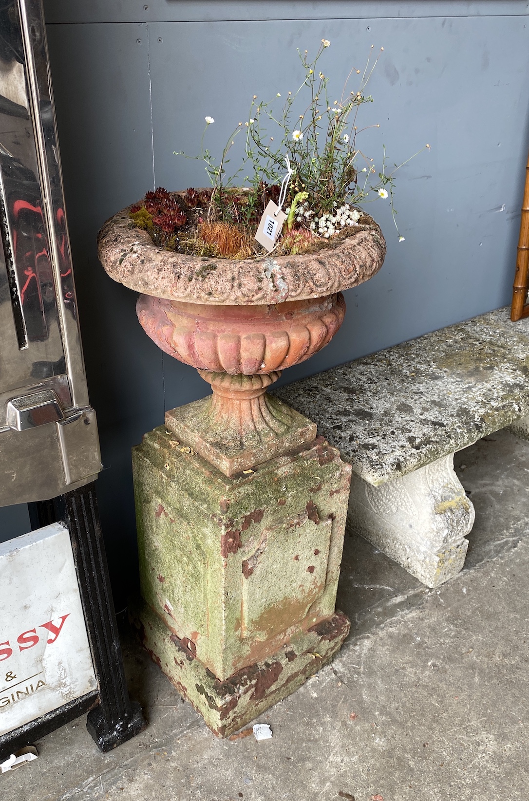 A pair of Victorian terracotta and stone campana garden urns on stands, one with losses, larger diameter 44cm, height 95cm